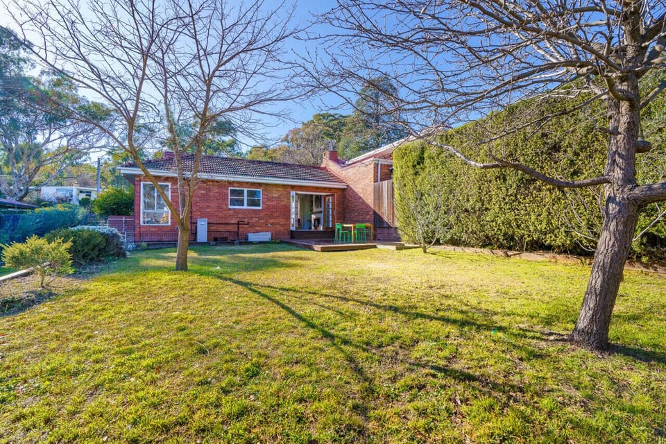 Relax in our spacious backyard surrounded by lush greenery. This expansive area offers a serene retreat with vibrant, well-maintained plants, creating a tranquil and inviting outdoor oasis.