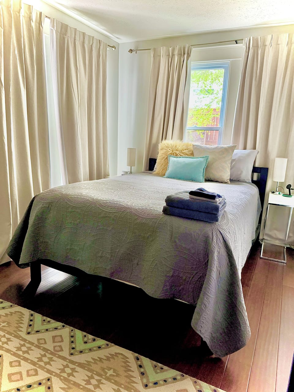 Queen bedroom with a brand-new mattress, plush bedding, blackout curtains.