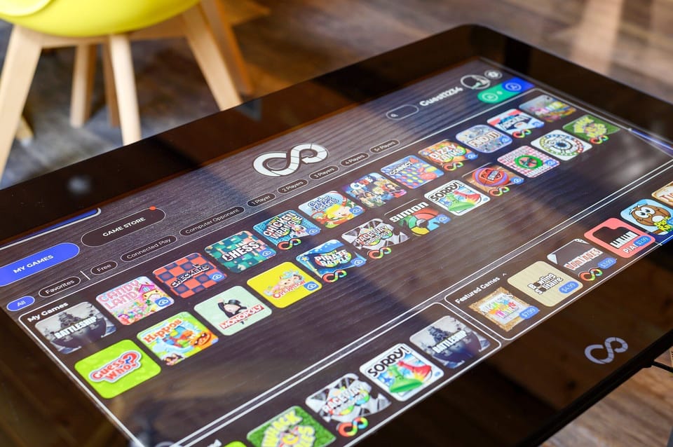 Play digital versions of 40+ games on a 32” touch screen, like Monopoly & more!