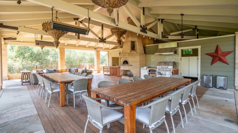 Enjoy the many outdoor dining options, like in the summer kitchen area to host a feast!