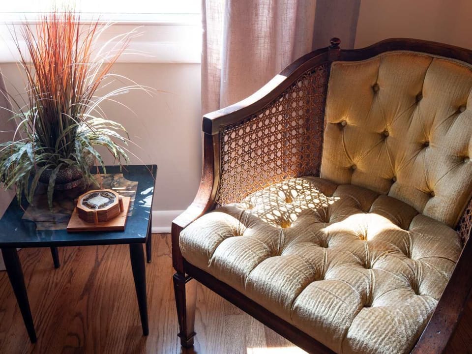 Sink into comfort and let the sunlight transform your space as you lounge in this charming wicker chair, the perfect spot for daydreaming!  #CozyCorner
