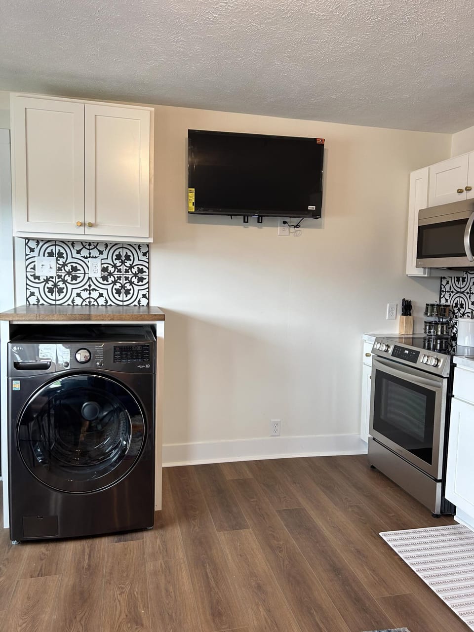 Queen 300 sq. ft. Studio at the Victorian Unit C living area and kitchen and tv