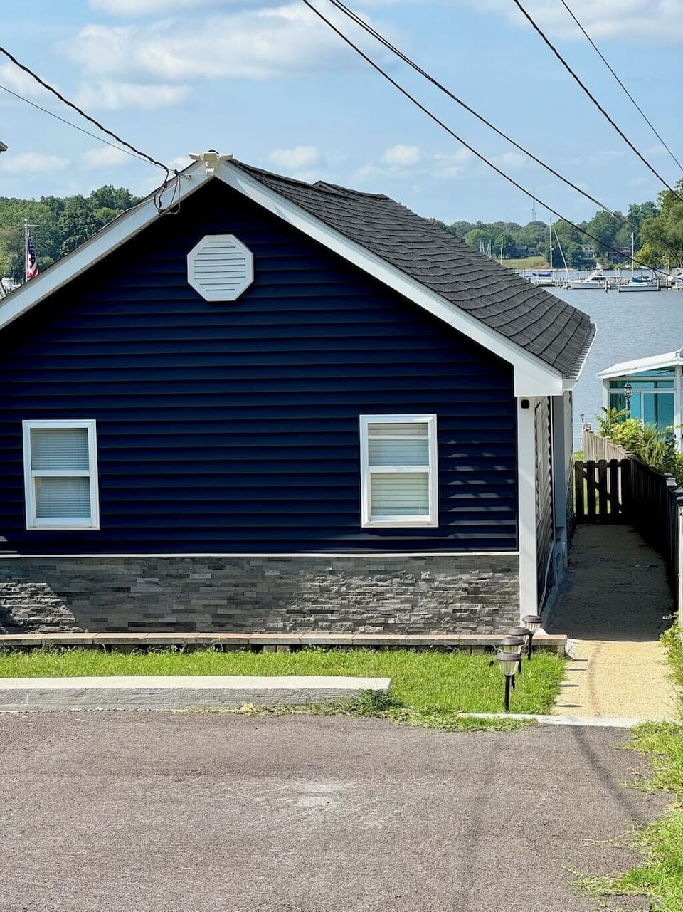 Front of house (by driveway). Entry door is on the right side of House