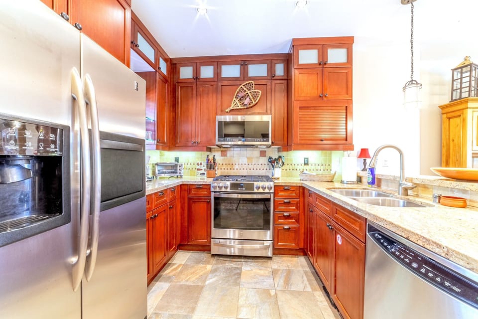 Kitchen has updated stainless steel appliances and granite countertops.