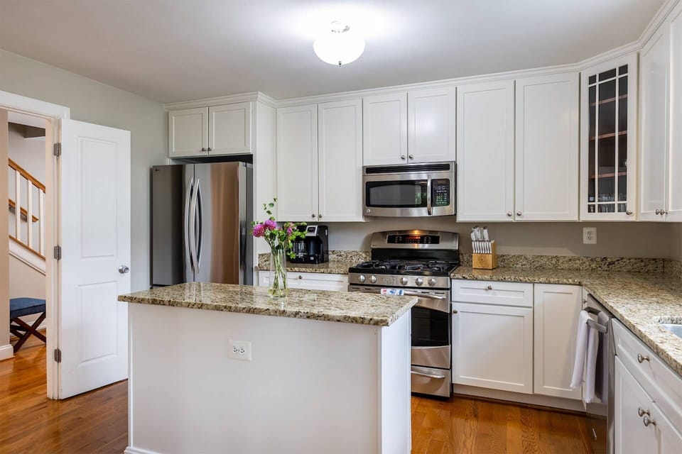 The kitchen is equipped with large and small appliances, including a Keurig/coffepot combo with starter coffee grounds and K-cups.