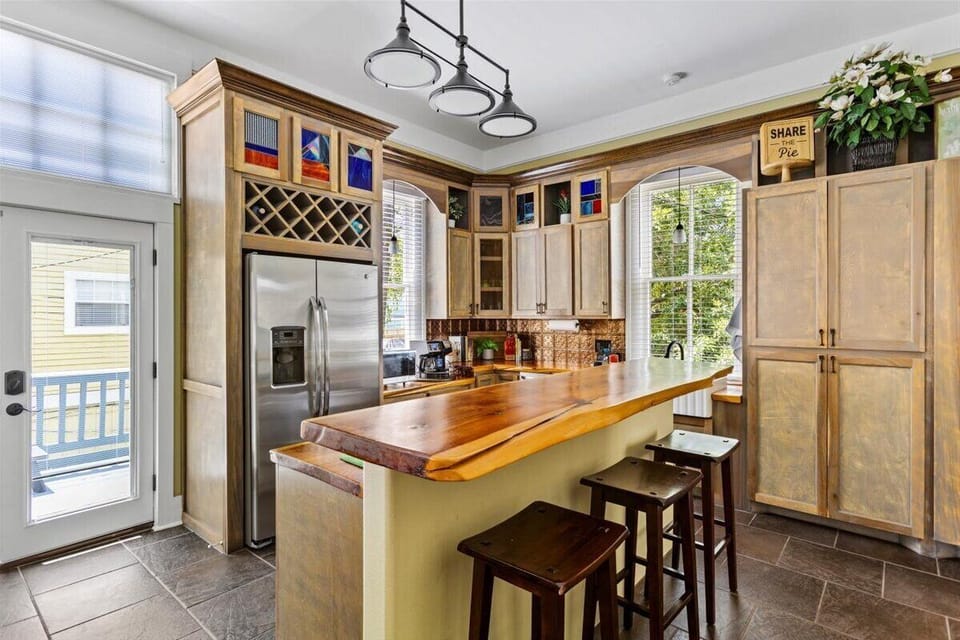 Stunning kitchen with wood island, ample storage, and stained glass accents!