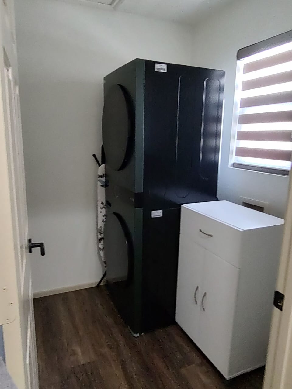 The utility room is accessed from the master bathroom with a stacked wash/dryer