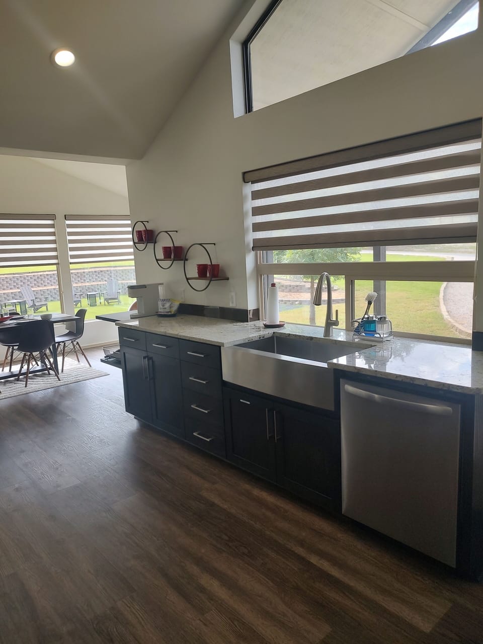 The kitchen is fully equipped with modern appliances and a farm house sink.