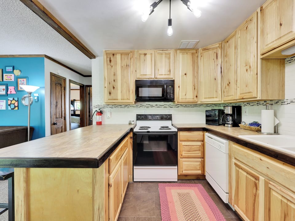 View of Kitchen with Counter Seating for 4, Electric Oven/Stove, Microwave, Dishwasher & Refrigerator