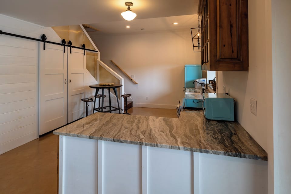 dining area off of 2nd kitchen, laundry area located inside barn doors