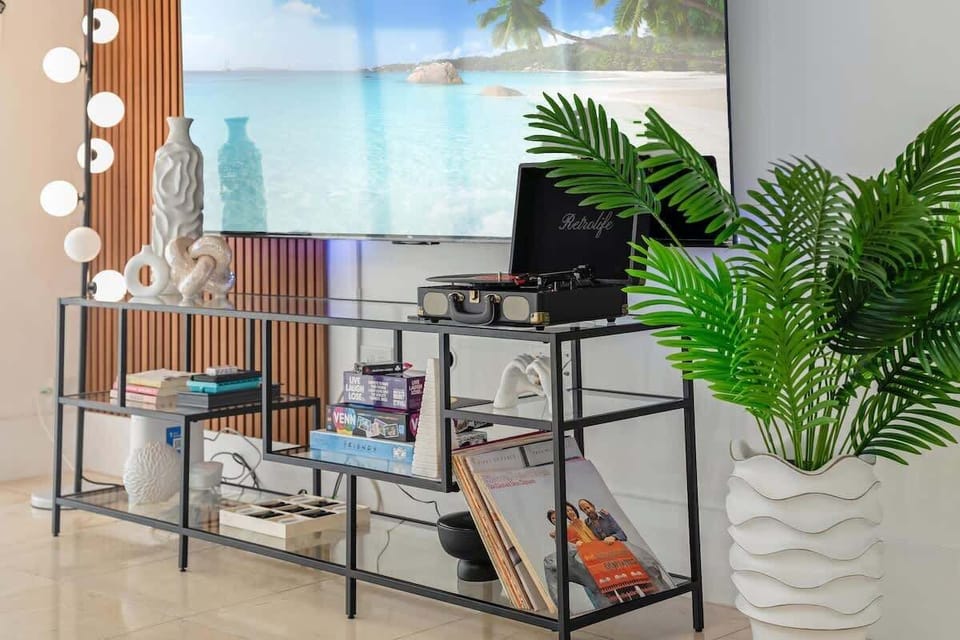Cozy living made easy with records, books, and games for all ages. This stylish space is perfect for unwinding with family after beach days or pool fun. Thoughtful touches make every stay feel like home. #FamilyVibes #VacationHome #AventuraStay