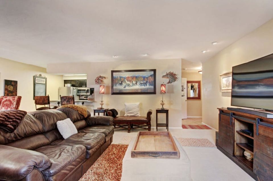 Enjoy quality time in the additional living area, offering ample seating, a large flat-screen TV, and tasteful decor that makes it a perfect spot for entertaining guests or enjoying a quiet evening.