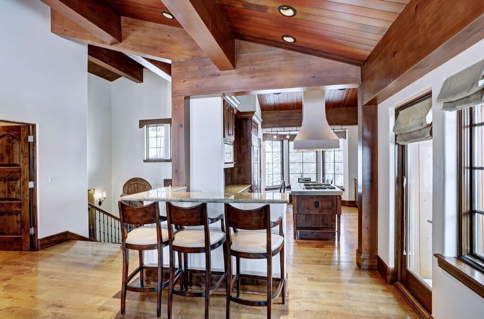 Unwind in the inviting bar and lounge area, featuring comfortable barstools, a wooden bar, and a relaxed setting perfect for socializing.