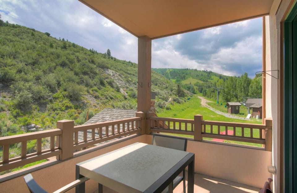 Enjoy breathtaking views from the scenic balcony, featuring a comfortable seating area perfect for outdoor dining or simply relaxing while taking in the beautiful surroundings.