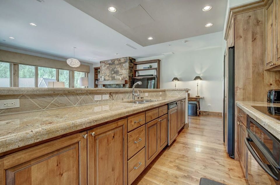 Enjoy cooking in the expansive kitchen, featuring a large island, modern appliances, and plenty of counter space for all your culinary adventures.