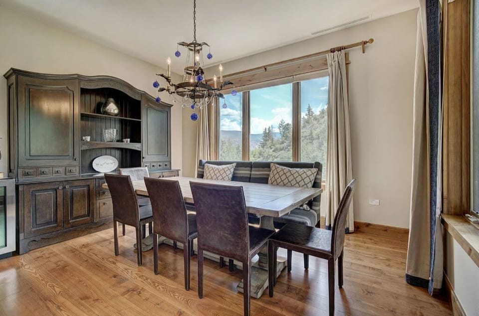 Host exquisite dinners in the formal dining area, complete with a beautiful chandelier, a large dining table, and comfortable seating for all guests.