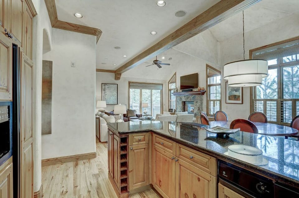 Enjoy cooking in the spacious kitchen, featuring a large island with bar seating, modern appliances, and beautiful wood cabinetry.