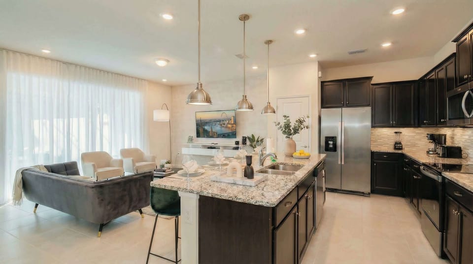Spacious open kitchen and living area with upscale finishes and natural light.