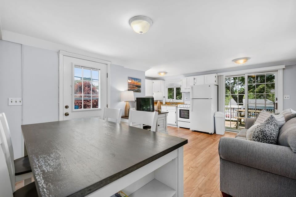 View from the table across the living space to the kitchen - 251 Old Wharf Road Unit 163 Dennis Port - Hilltop Hideaway