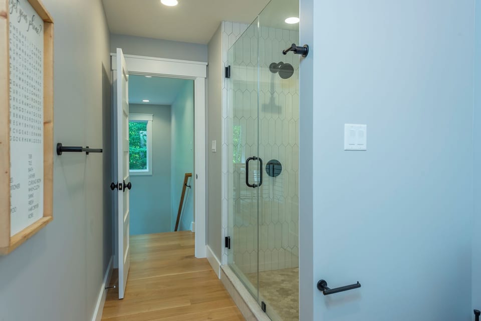 Upper-level bathroom with walk-in shower and hallway access