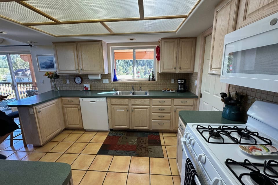 Well appointed kitchen with carafe style coffee pot and gas stove. Two homes in one, means two kitchens to choose from! Great for multi families!