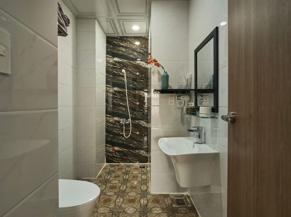 Family Room, 2 Queen Beds, Non Smoking, City View | Bathroom | Hair dryer, slippers, soap, shampoo