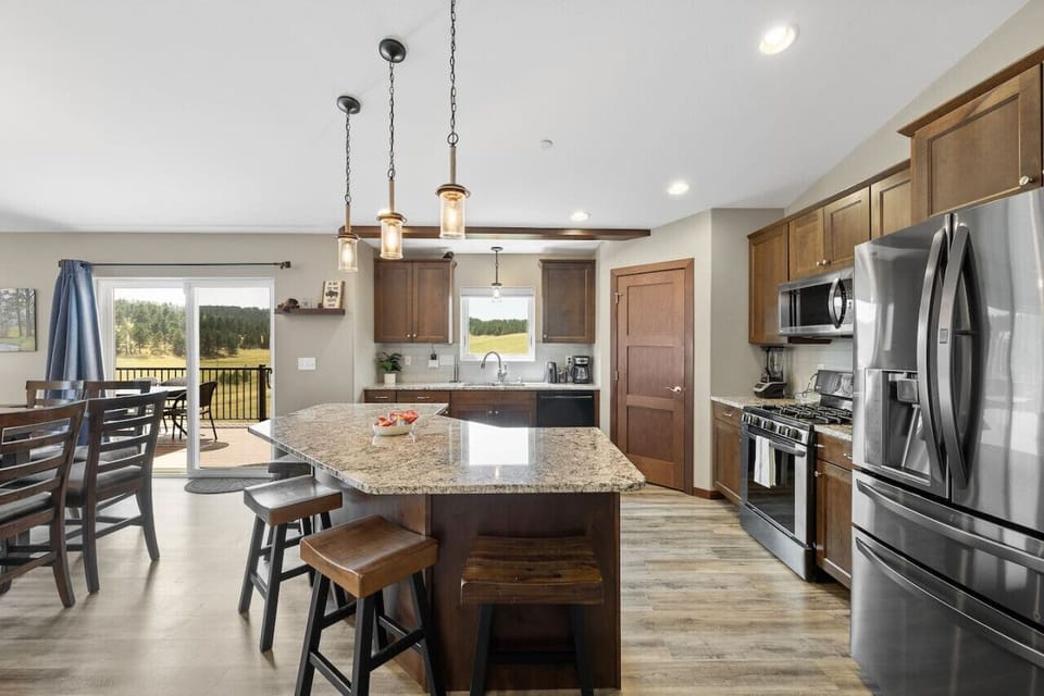 A fully stocked kitchen featuring a stove, dishwasher, refrigerator, and microwave for all your cooking and convenience needs.