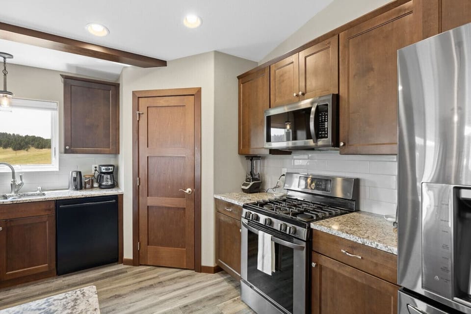 Our fully-equipped kitchen is a chef’s dream, featuring sleek countertops, top-of-the-line appliances, and plenty of room to prep, cook, and entertain.