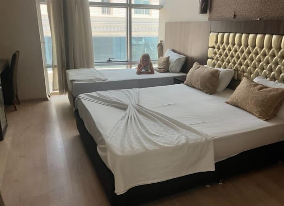 Deluxe Triple Room, City View | Minibar, blackout drapes, free WiFi, bed sheets