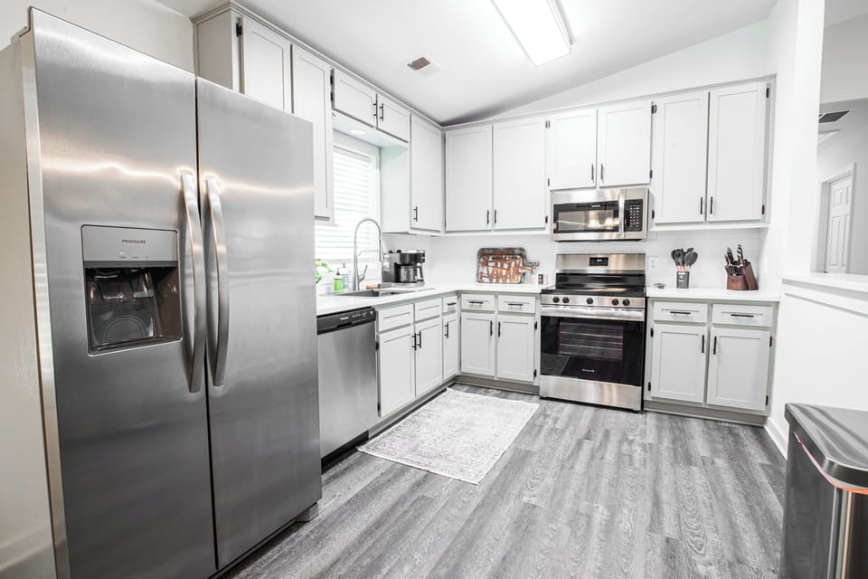 Kitchen with side by side refrigerator, water/ice in door. All appliances new. 