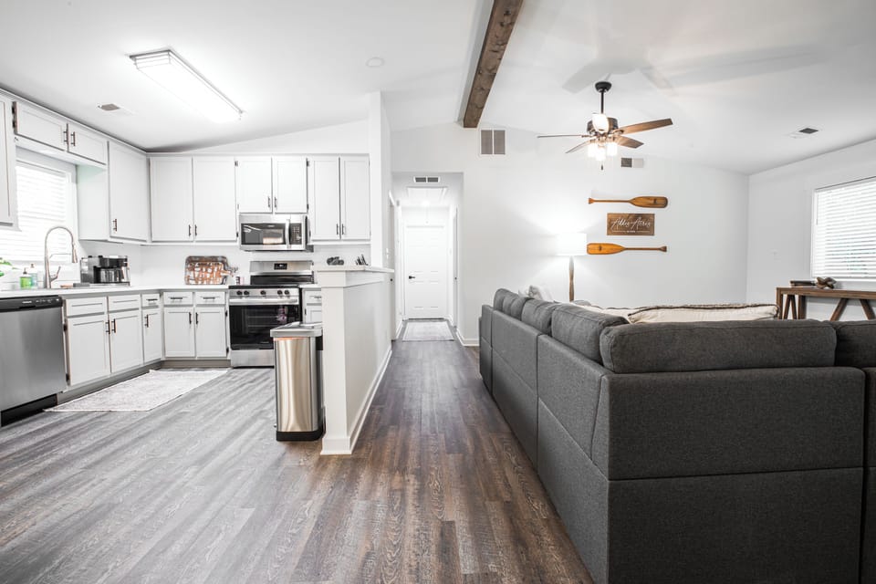 Living room, hallway leading to bedrooms, and kitchen
