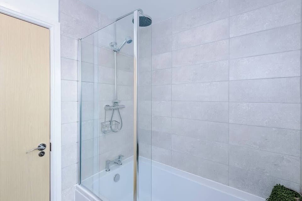 The main bathroom just off the entrance hallway benefits from a toilet, sink and bath with an overhead shower.