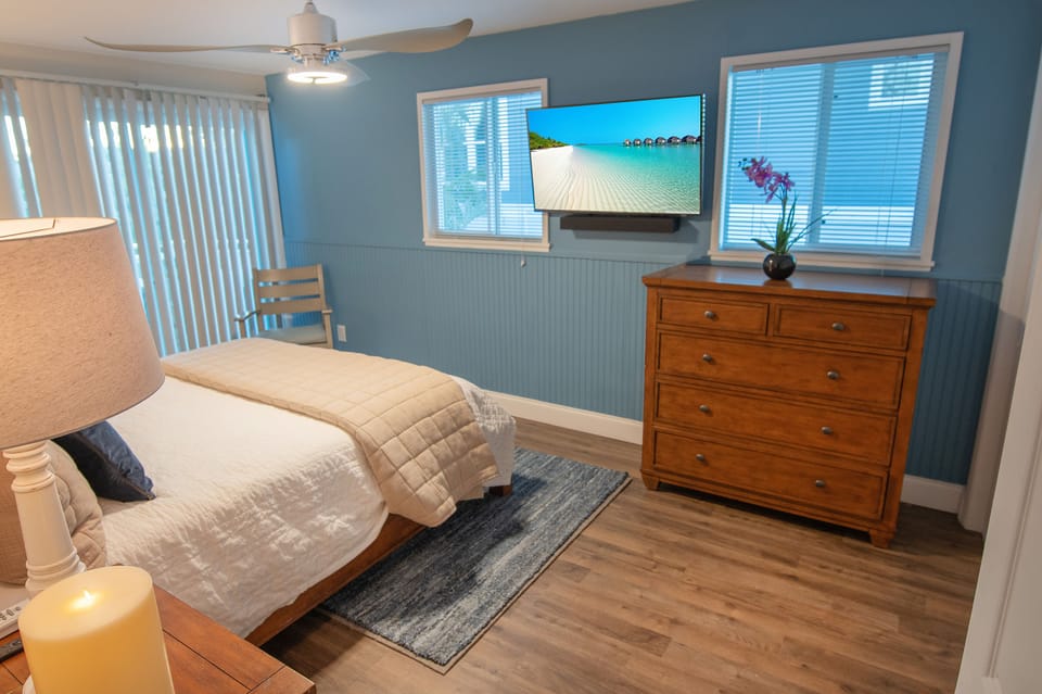 The Level 2 bedroom features a dresser, Smart TV, and a full closet for ample storage. This beautiful home includes a total of 6 bedrooms.