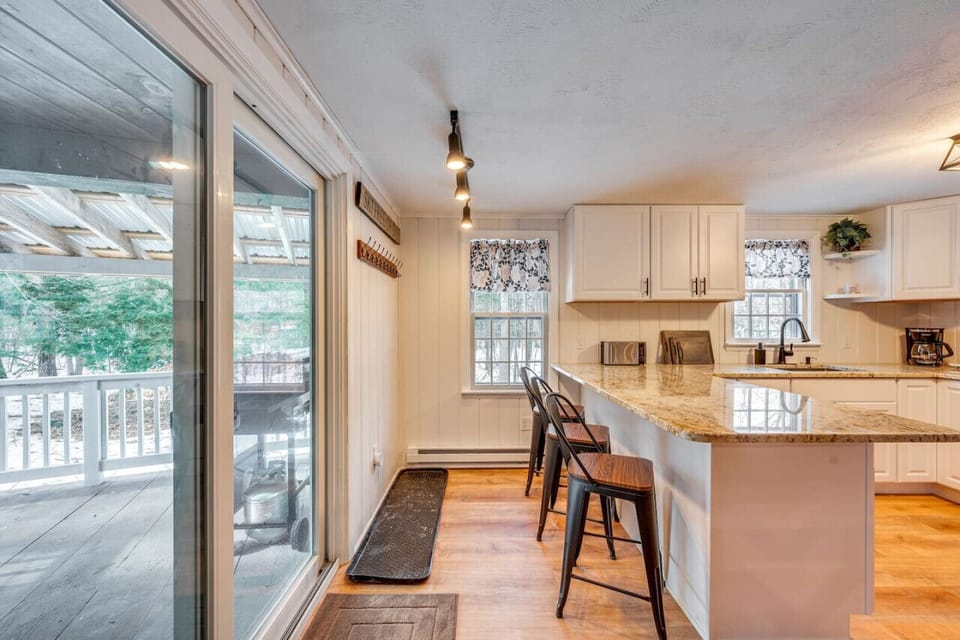 Spacious kitchen with a breakfast bar and sliding glass doors leading to a deck