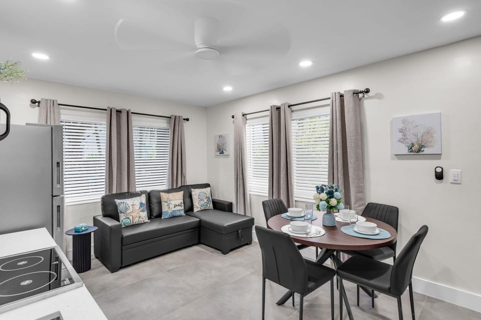 Enjoy meals at the dining table with seating for four, conveniently located between the kitchen and living room.