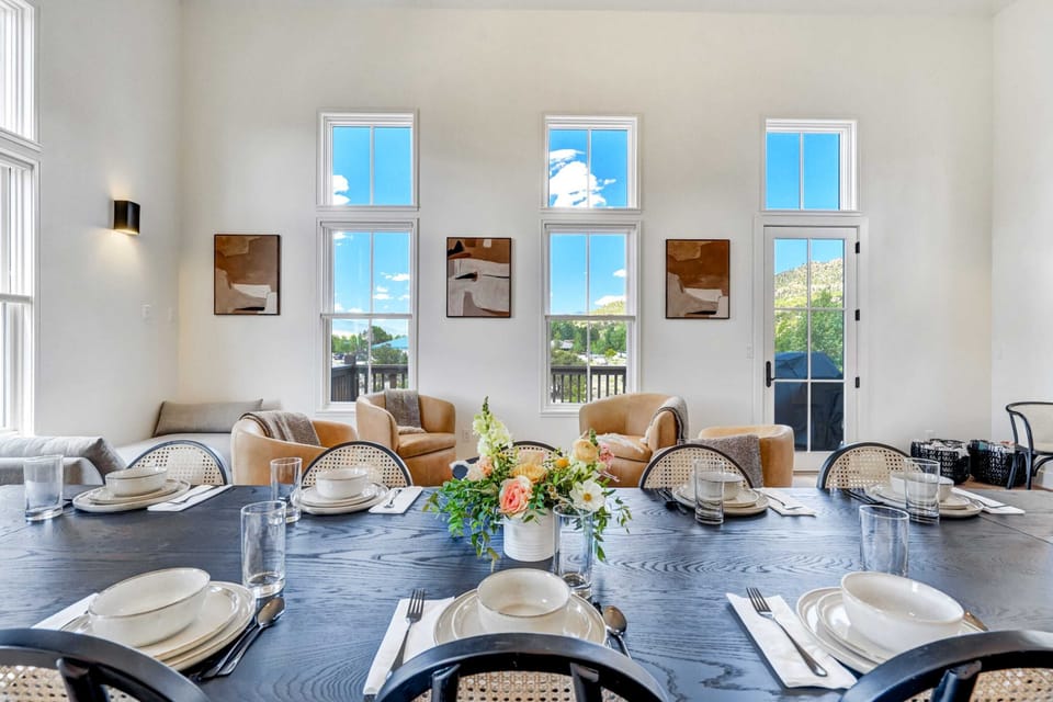 Elegant open-plan living and dining area with high ceilings and ample natural light.