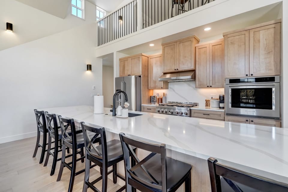 Modern kitchen with high-end appliances, large island, and stunning views.