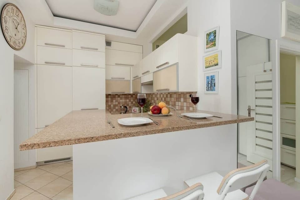 Bright kitchen with cooking utensils. 