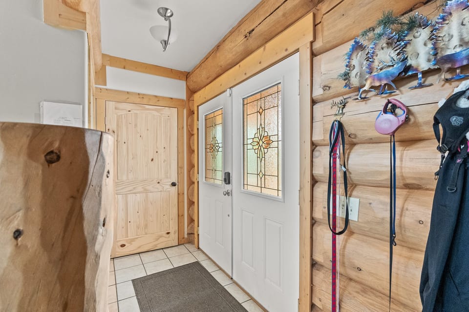 Hooks installed beside the door for convenient hanging of bags, hats, or towels.