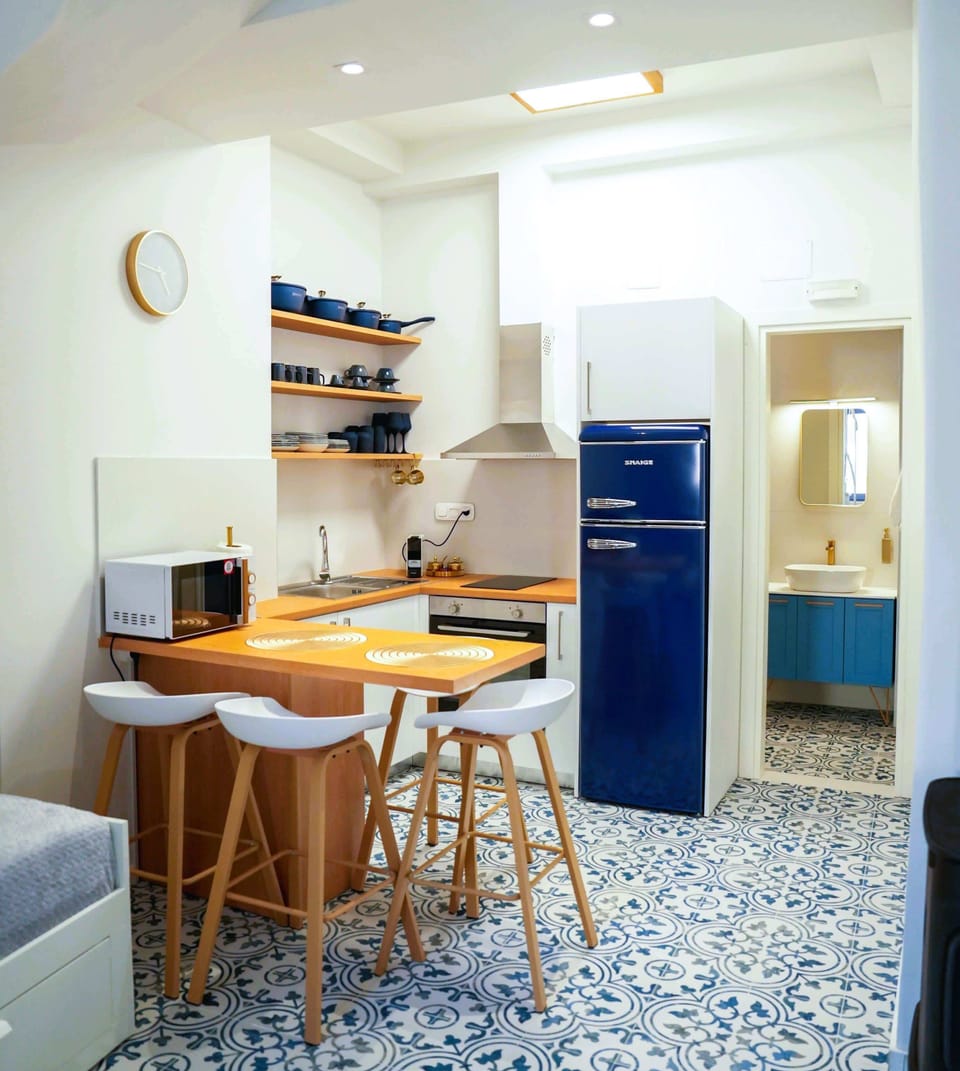 Fully Equipped Kitchen with Stove, Fridge, Sink, and Ample Counter Space for Cooking

