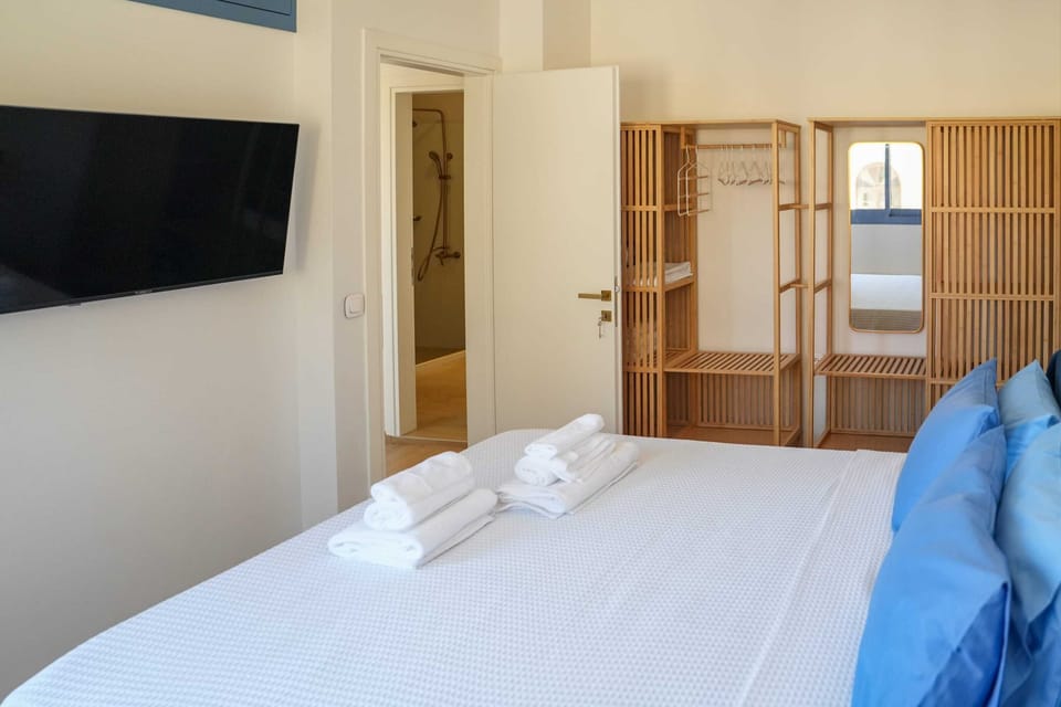 Bedroom 1 Interior View with Wardrobe, TV, and Ample Space for Luggage

