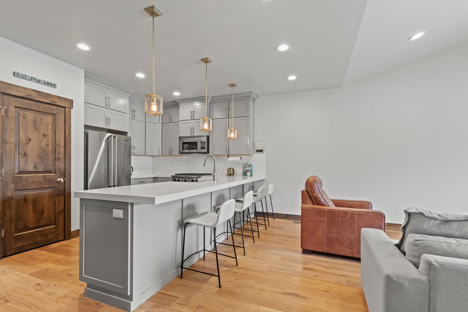 Cook together in this bright, open kitchen with stainless appliances, sleek quartz counters, and a spacious island where you can gather for meals and conversation.