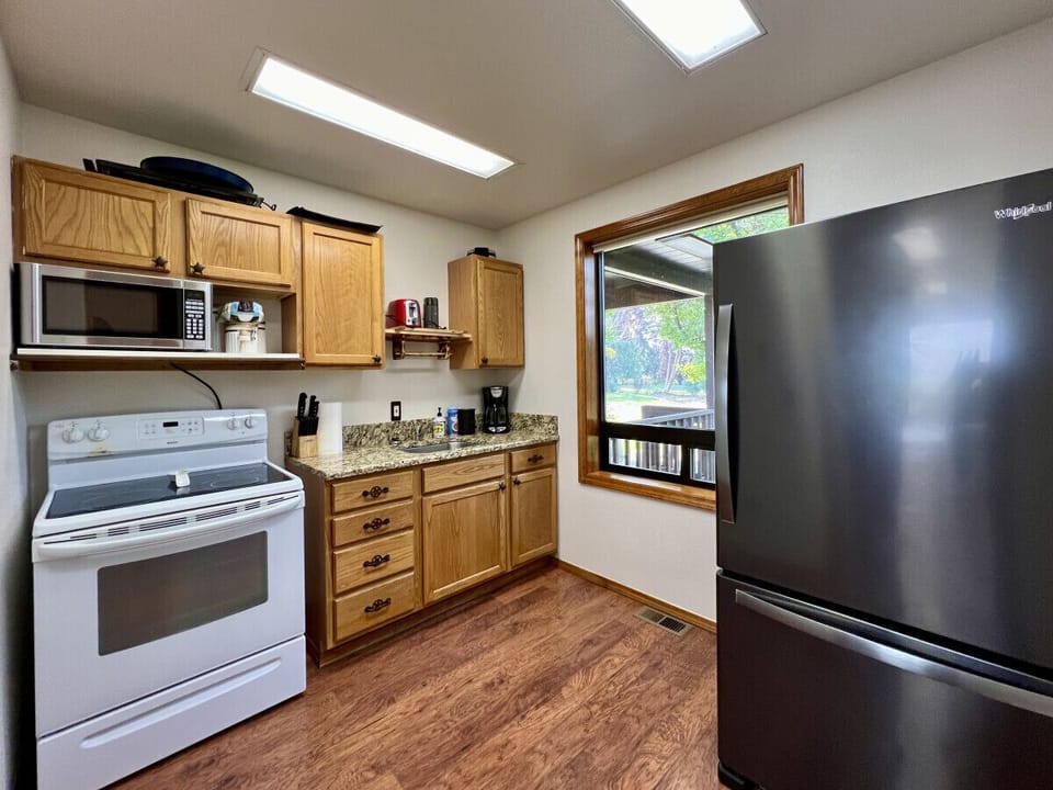 Kitchen with electric stove and microwave