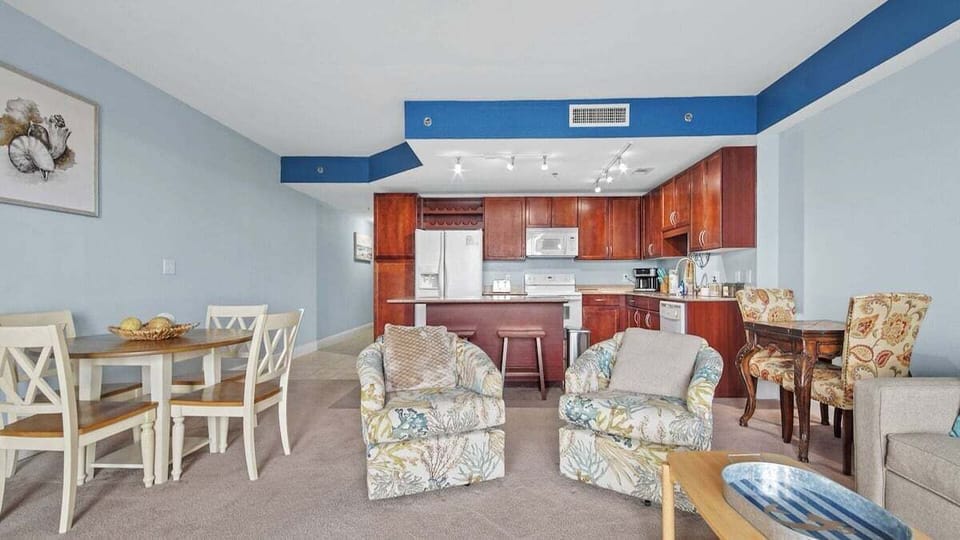 Living room with queen size sleeper sofa (sleeps 2) and access to balcony.