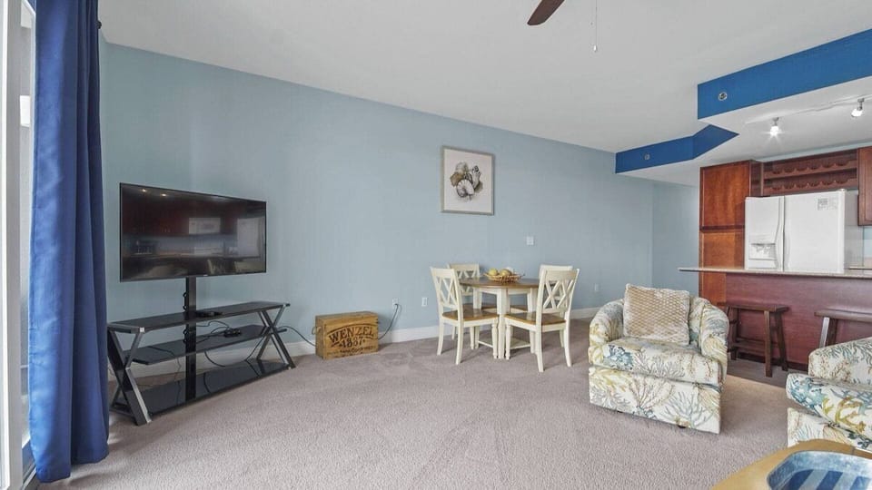 Living room with queen size sleeper sofa (sleeps 2) and access to balcony.