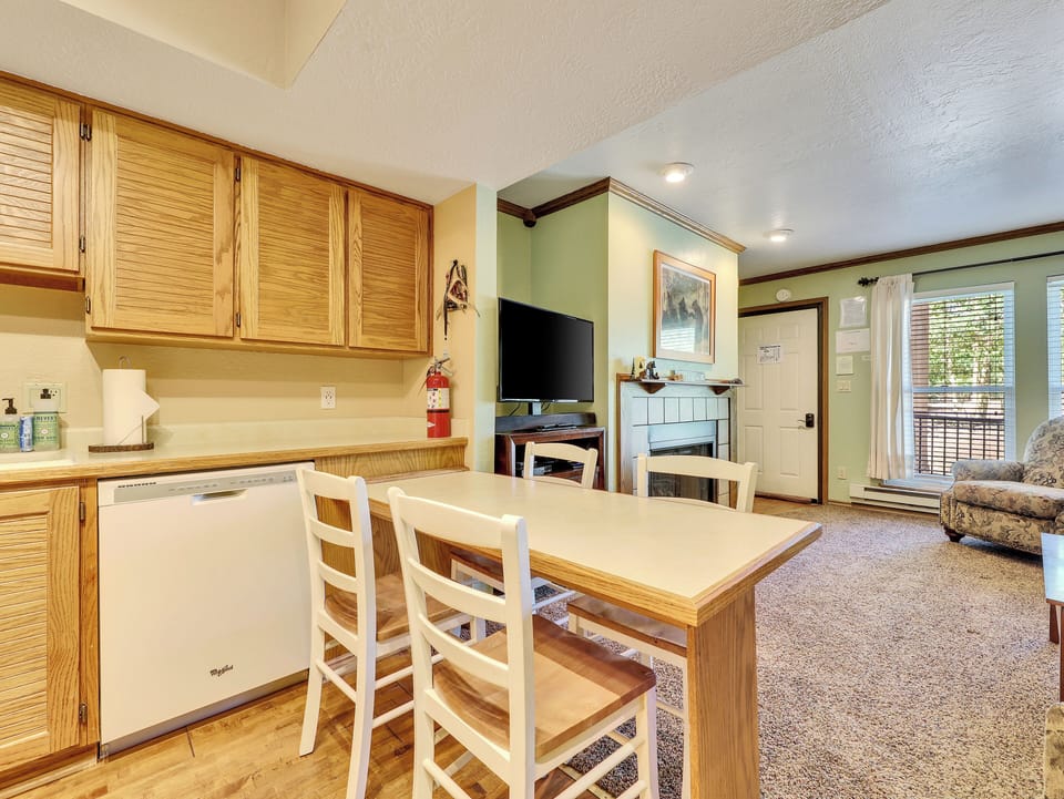 View of Dining Area, seating for 4, dishwasher and upper kitchen cabinets