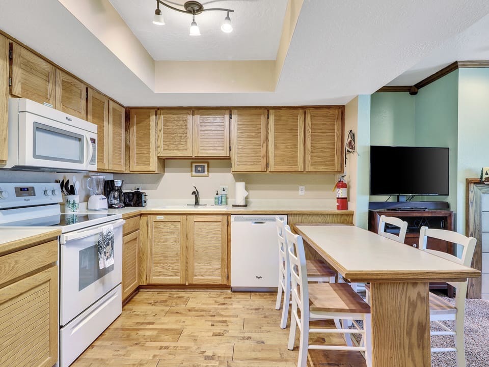 View of Kitchen, refrigerator, stove/oven, microwave, toaster, coffee maker, ample counter space and dining area