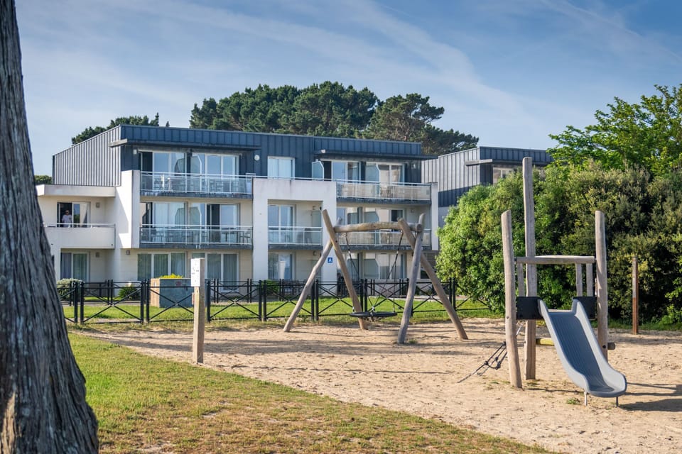 Little ones can swing and slide right outside, with the balconied buildings just behind.