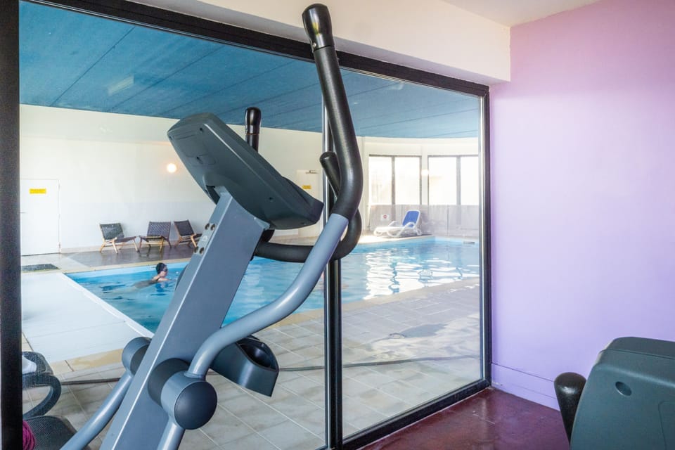 Keep an eye on the pool from the fitness room while someone takes a few laps below.