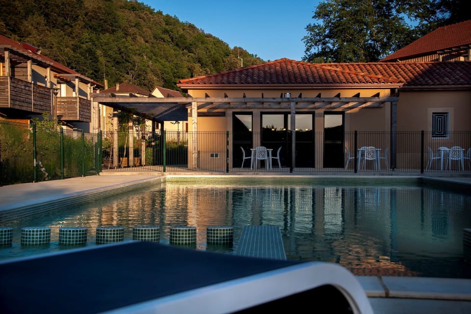 Relax by the pool as the sun sets, offering an inviting escape with a soothing atmosphere.
